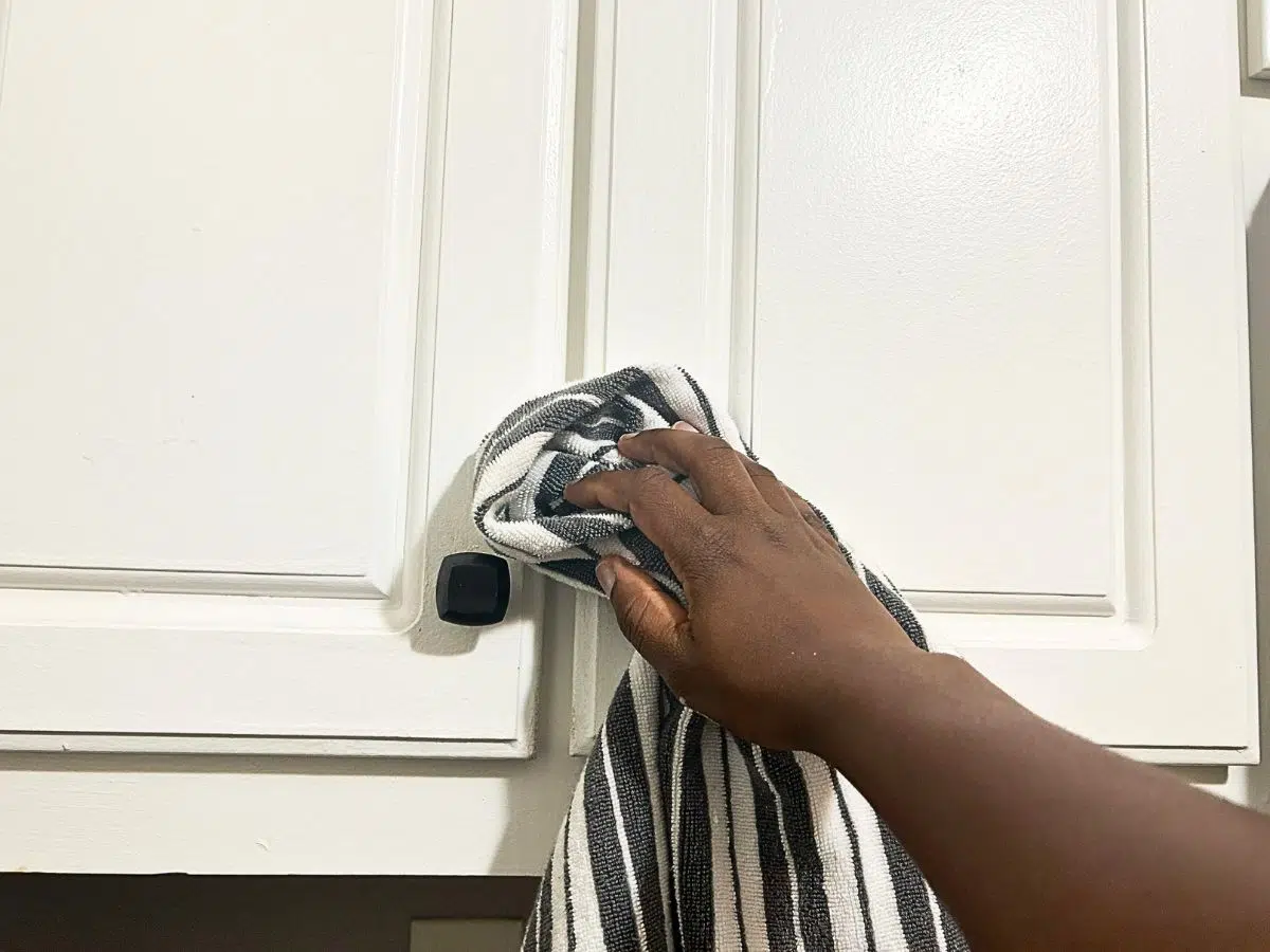 wiping down kitchen cabinets