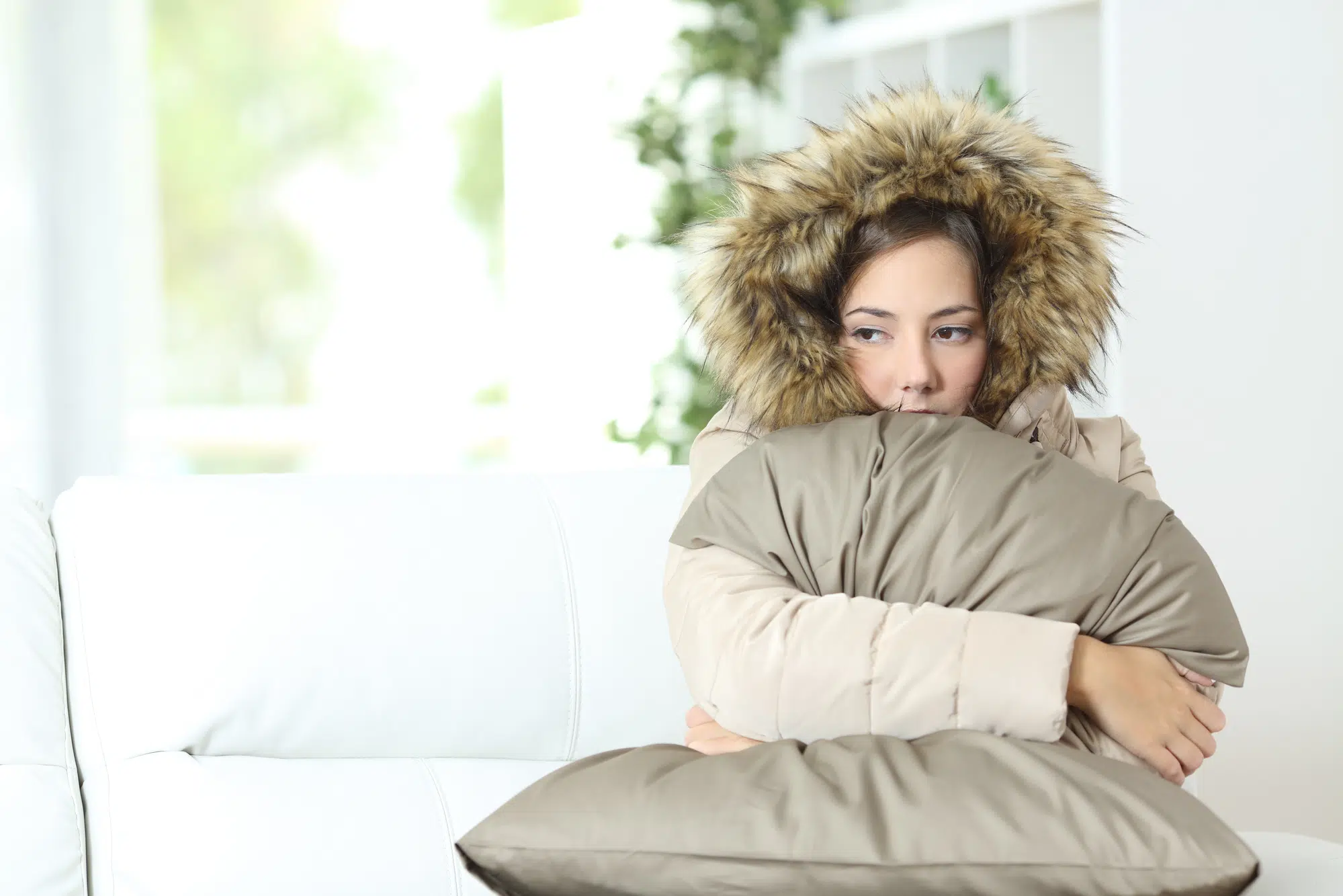 Woman warmly clothed in a cold home