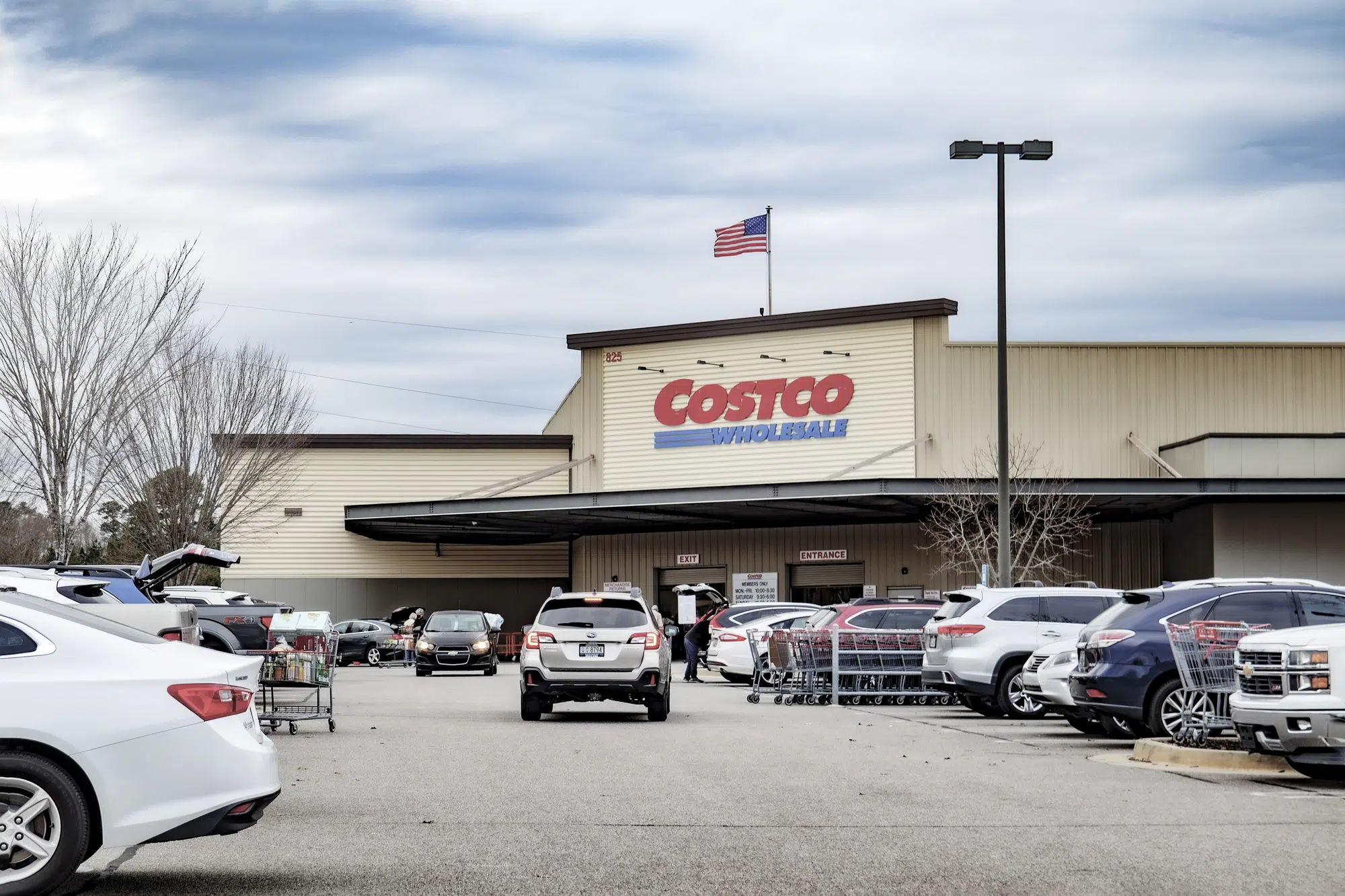 Costco retail superstore building and sign with people and cars
