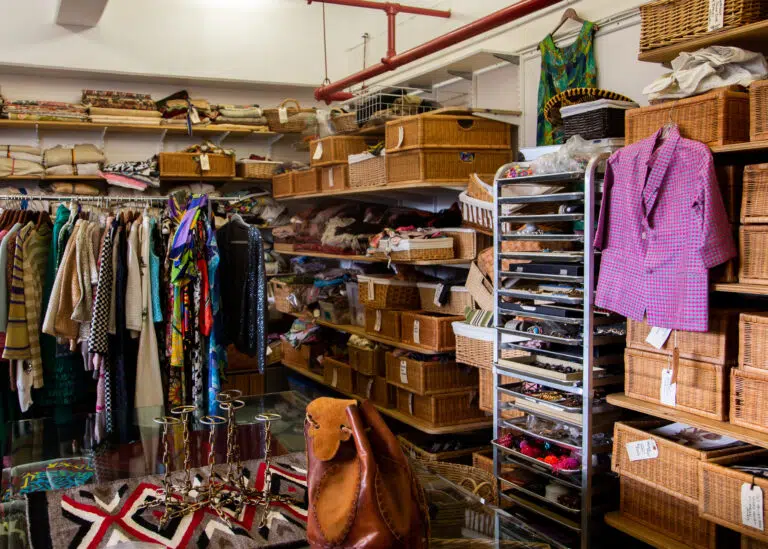 The interior and items of a vintage thrift clothing store with fashionable clothing and accessories vintage thrift store