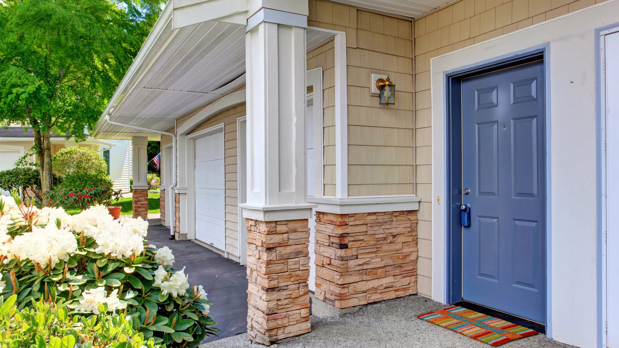 Column entrance porch with blue door and colorful rug
