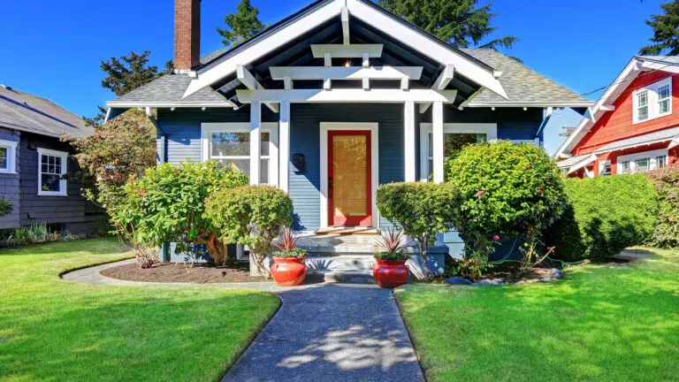 Simple house exterior with tile roof. Front porch with curb appeal