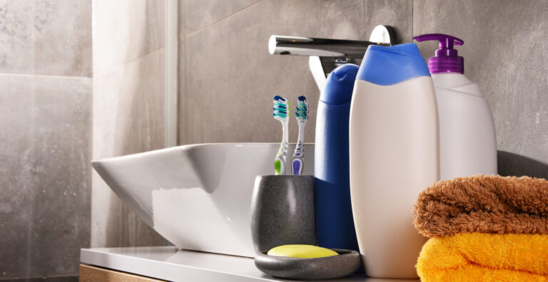 Plastic bottles of body care and beauty products in the bathroom