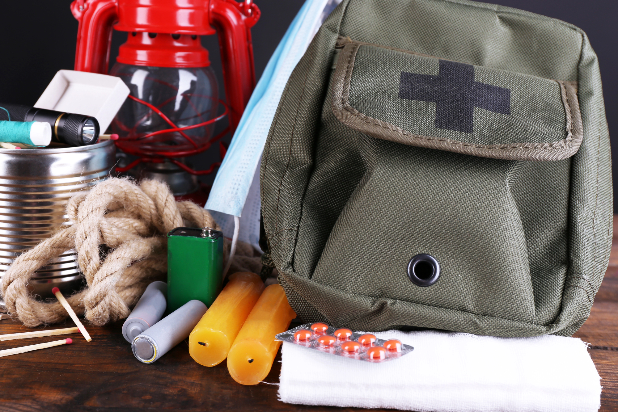 Emergency preparation equipment on wooden table bug out bag, supplies rope