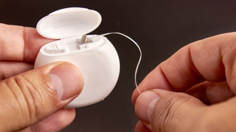 dental floss with hands