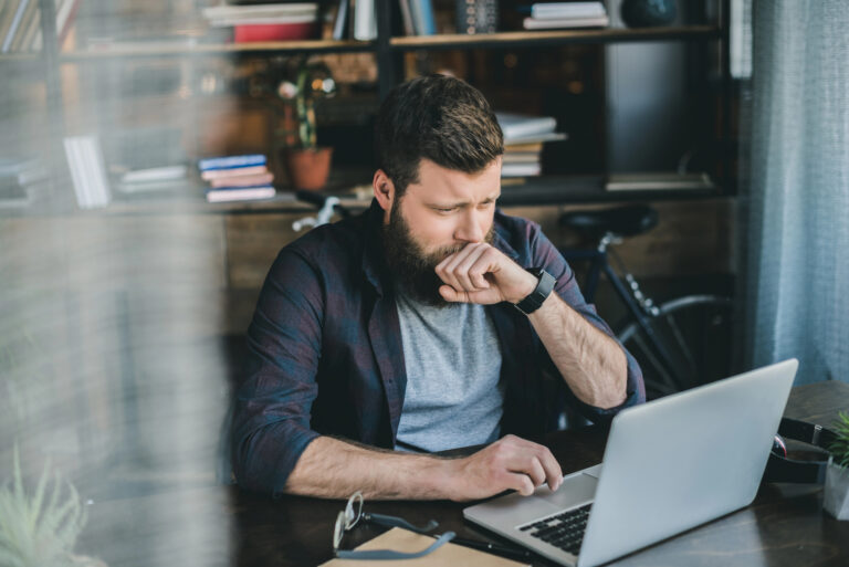 man typing on laptop