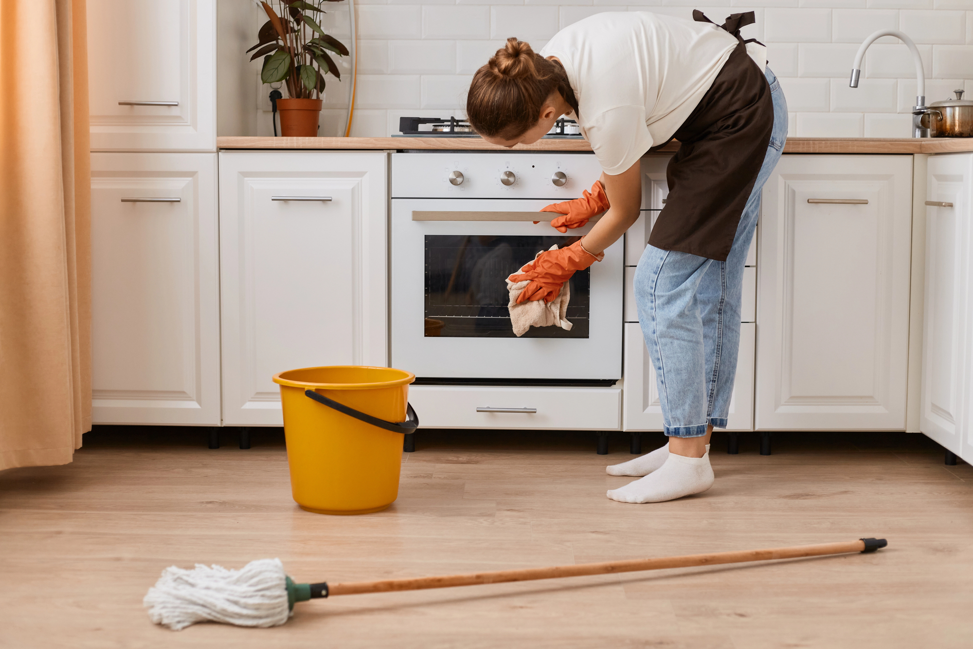 woman cleaning stove