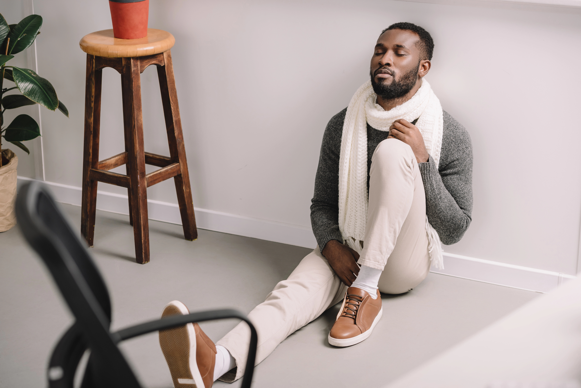 man sitting on floor worrying