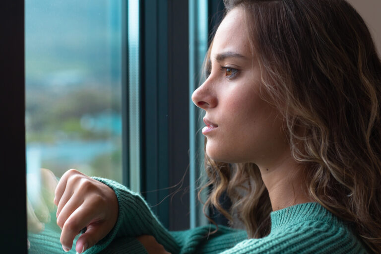 woman looking out the window