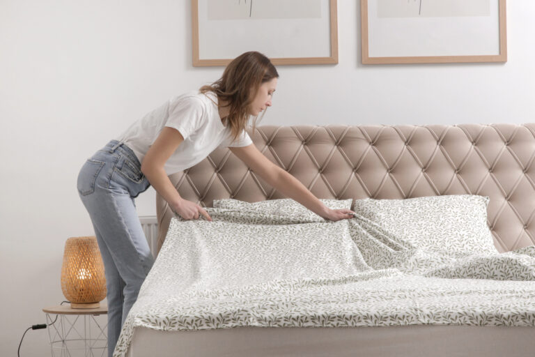 woman spreading bed